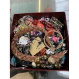 A METAL TIN CONTAINING ASSORTED COSTUME JEWELLERY