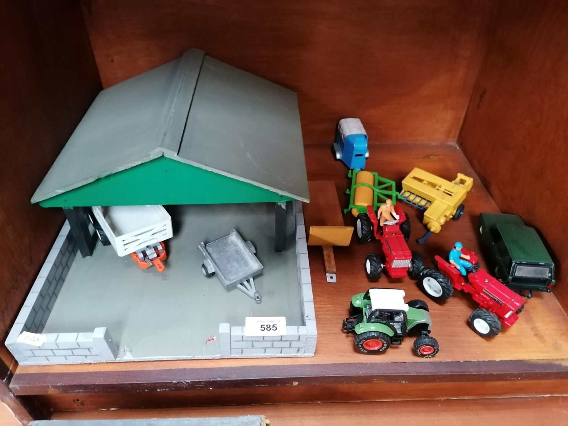 A WOODEN GARAGE WITH ASSORTED FARMYARD TOY MODELS ETC