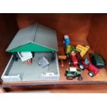 A WOODEN GARAGE WITH ASSORTED FARMYARD TOY MODELS ETC