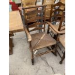 AN OAK LADDER BACK ROCKING CHAIR WITH RUSH SEAT