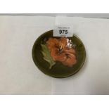 A MOORCROFT POTTERY HIBISCUS PATTERN SMALL DISH, PAPER LABEL TO BASE