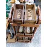 A WOODEN STAND WITH VINTAGE STYLE BRICK MOULDS