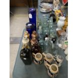 A COLLECTION OF ASSORTED GLASS BOTTLES AND JARS TOGETHER WITH FOUR TANKARD CUPS