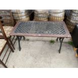 A PATIO DINING TABLE WITH CAST IRON ENDS AND LATTICE TOP