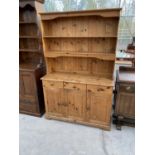 A PINE DRESSER WITH THREE DOORS, THREE DRAWERS AND UPPER PLATE RACK