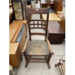 AN OAK ROCKING CHAIR WITH RUSH SEAT