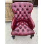 A RED LEATHER CHESTERFIELD STYLE ARMCHAIR WITH BUTTONED SEAT AND BACK