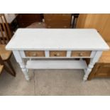 A WHITE AND PINE SIDE TABLE WITH THREE DRAWERS AND LOWER SHELF