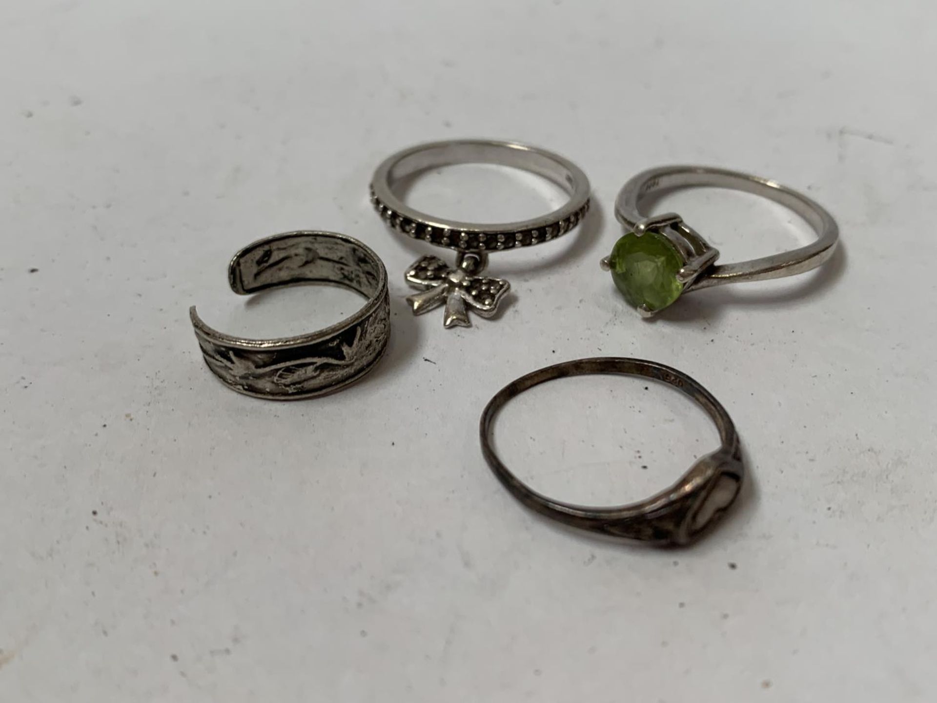 A COLLECTION OF FOUR ASSORTED SILVER RINGS