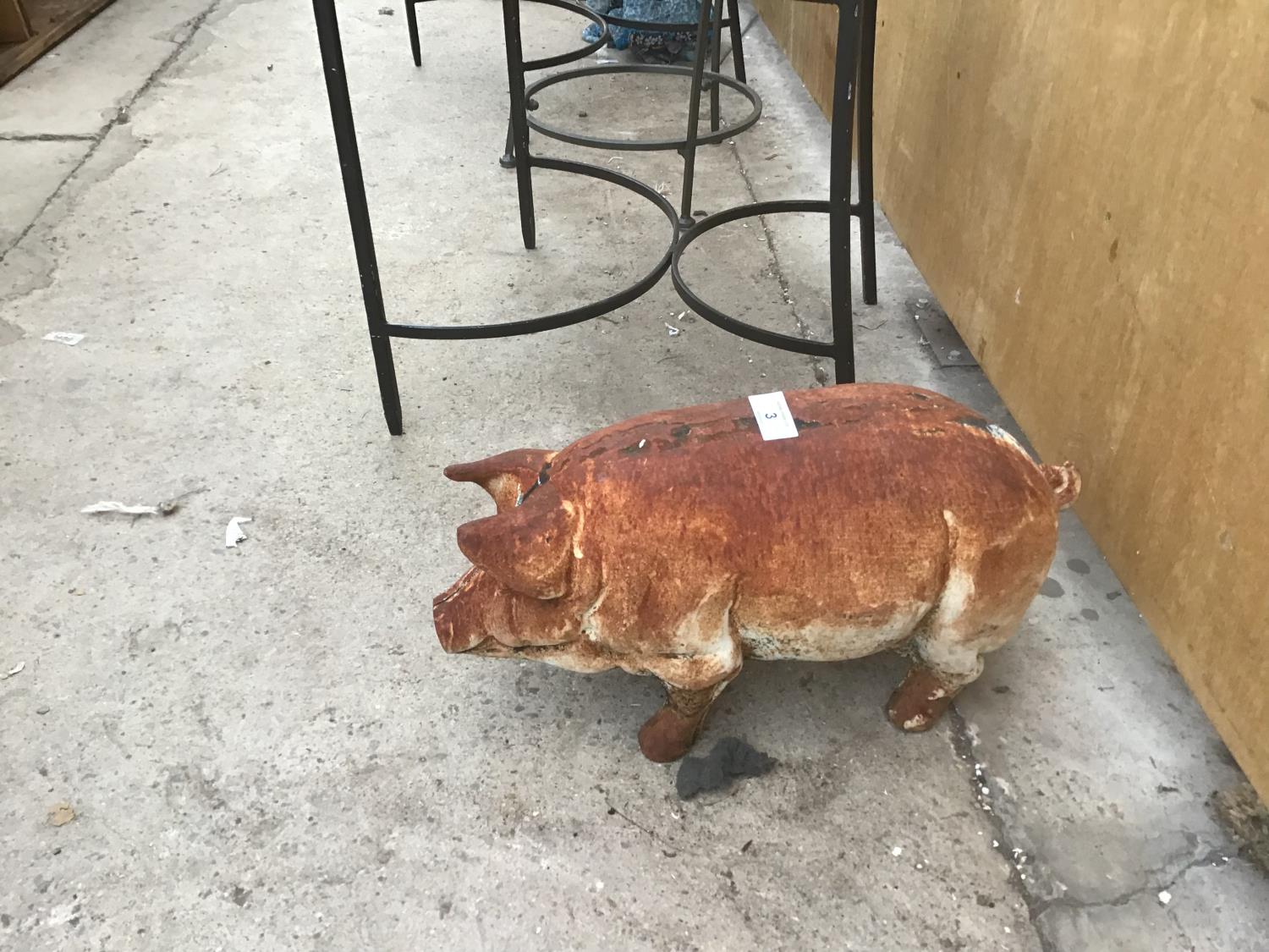 A METAL PIG ORNAMENT