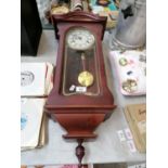 A LINCOLN 31 DAY WALL CLOCK WITH PENDULUM AND KEY