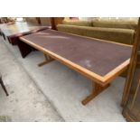 A LONG TEAK DINING TABLE