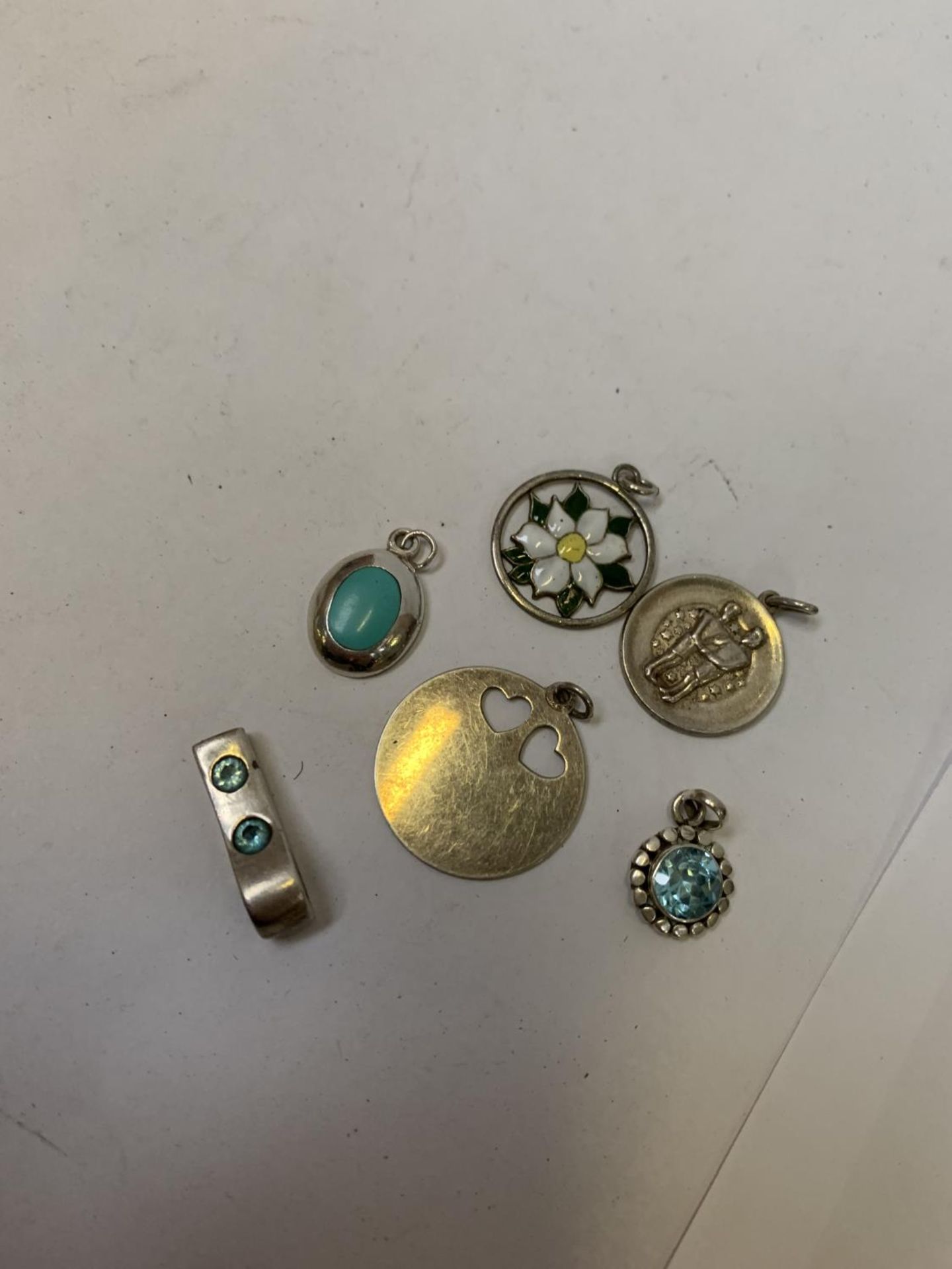 AN ASSORTMENT OF SIX SILVER PENDANTS