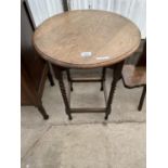 AN OAK OCCASIONAL TABLE ON BARLEY TWIST SUPPORTS