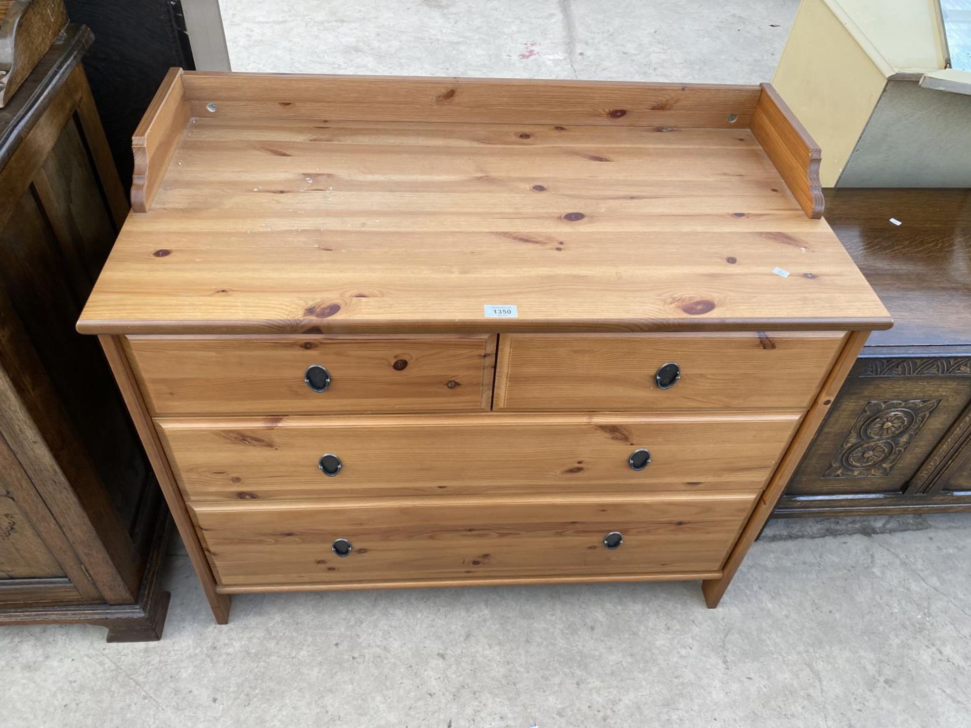 A PINE EFFECT CHEST OF TWO LONG AND TWO SHORT DRAWERS