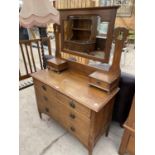 AN OAK ARTS AND CRAFTS STYLE DRESSING TABLE WITH THREE LONG DRAWERS, TWO UPPER SMALL DRAWERS AND