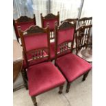 FOUR CARVED OAK DINING CHAIRS WITH RED VELVET STYLE UPHOLSTERED SEATS AND BACKS