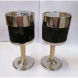 A PAIR OF CHROME DRINKING GOBLETS WITH INTRICATE CARVED IVORY STEMS