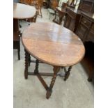 AN OVAL OAK DROP LEAF DINING TABLE ON BARLEY TWIST SUPPORTS