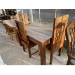 AN INDONESIAN WOOD DINING TABLE AND THREE DINING CHAIRS