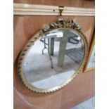 A CIRCULAR GILT FRAMED MIRROR