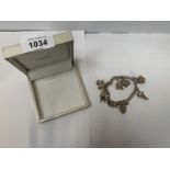 A BOXED SILVER BRACELET WITH SEVEN CHARMS