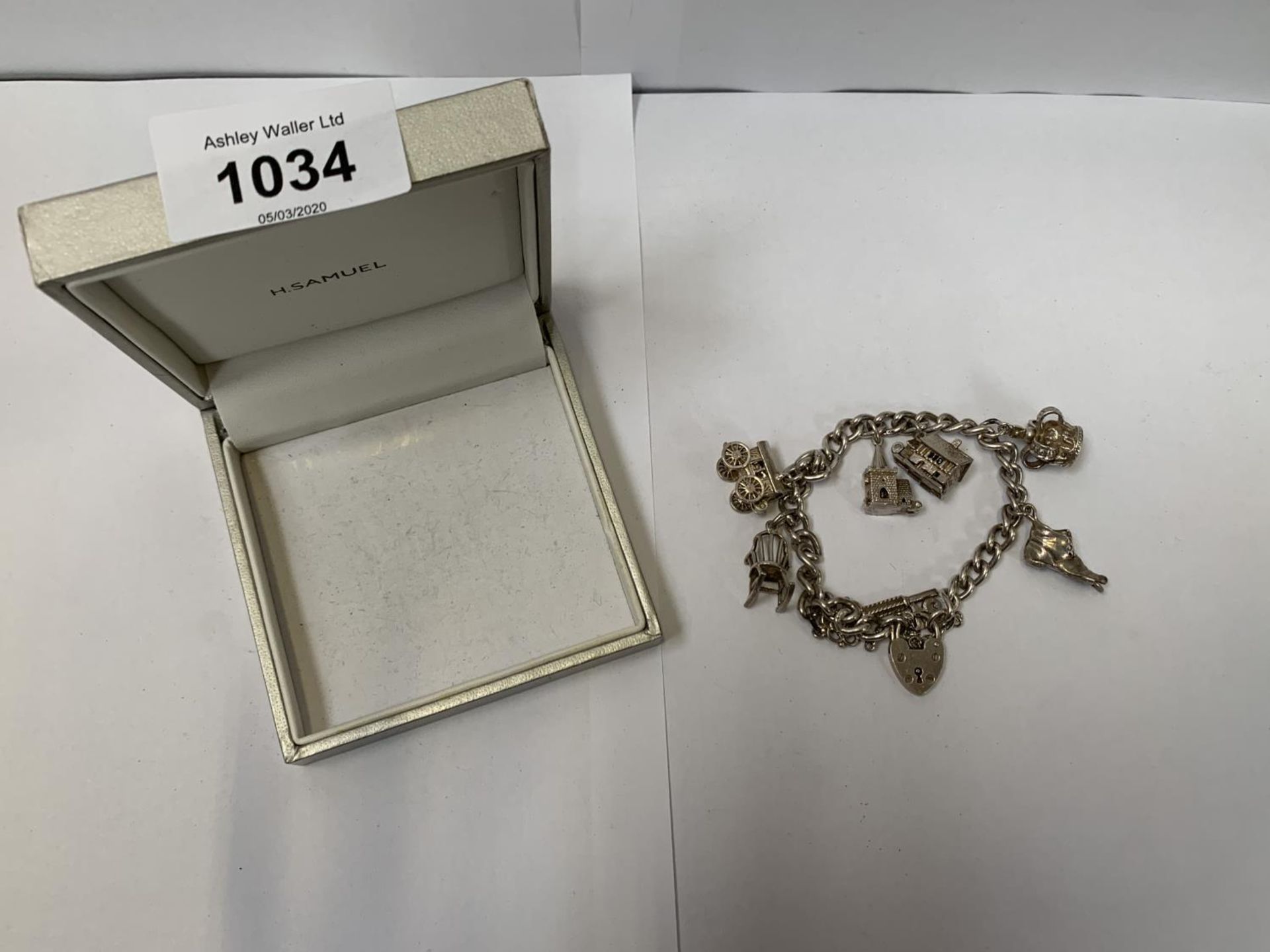 A BOXED SILVER BRACELET WITH SEVEN CHARMS