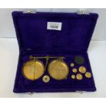 A BOXED SET OF BRASS WEIGHTS AND SCALES