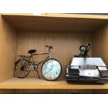 A METAL BIKE CLOCK AND A METAL TANK WINE BOTTLE HOLDER