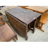 AN OAK DROP LEAF DINING TABLE