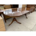 A MAHOGANY EXTENDING DINING TABLE ON TWIN PEDESTAL SUPPORTS