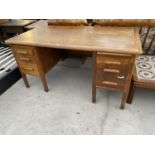 AN OAK TWIN PEDESTAL DESK WITH SIX DRAWERS