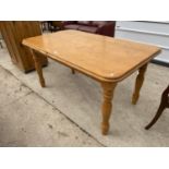 A RECTANGULAR PINE DINING TABLE