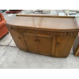 AN OAK SIDEBOARD WITH FOUR DOORS AND THREE DRAWERS