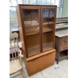 A RETRO TEAK CABINET WITH WITH TWO LOWER DOORS AND TWO UPPER GLAZED DOORS