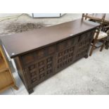 A YOUNGER TOLEDO OAK SIDEBOARD WITH THREE DOORS AND THREE DRAWERS