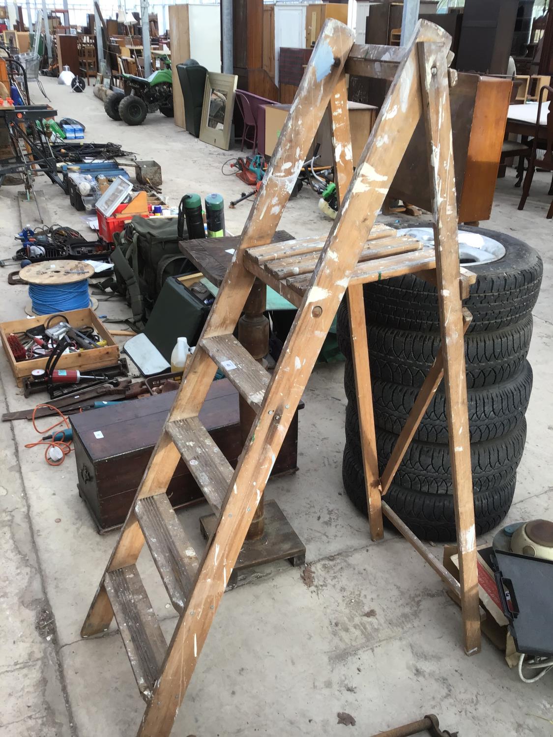 A SET OF VINTAGE FOUR STEP WOODEN STEP LADDERS AND A WOODEN PLANT STAND