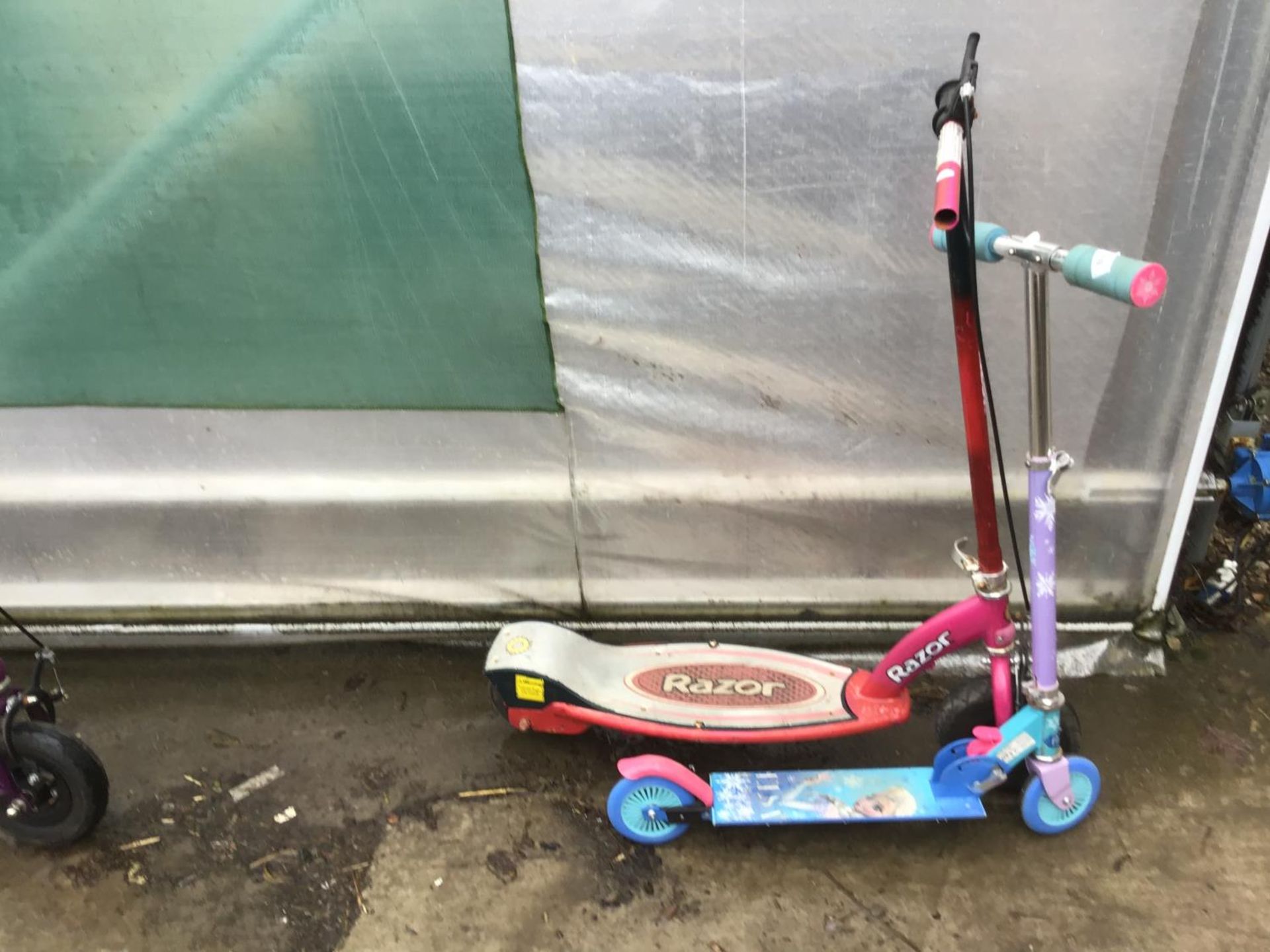 A RED RAZOR SCOOTER AND A FROZEN SCOOTER