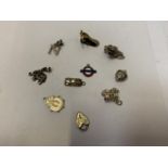 A COLLECTION OF TEN SILVER CHARMS