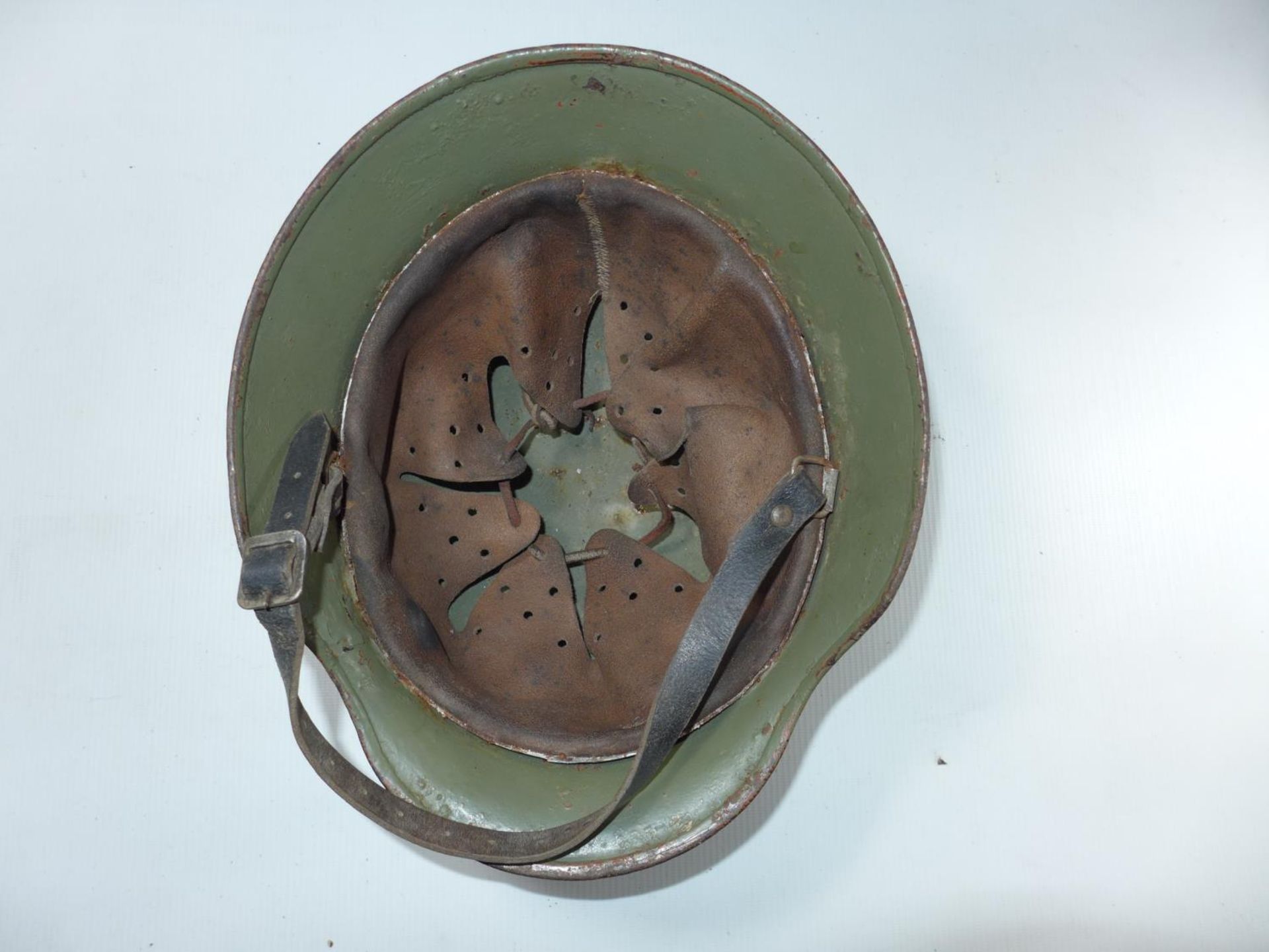 A GERMAN RUSTED AND GREEN PAINTED HELMET - Image 3 of 4