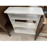 A WHITE PAINTED THREE TIER BOOKCASE