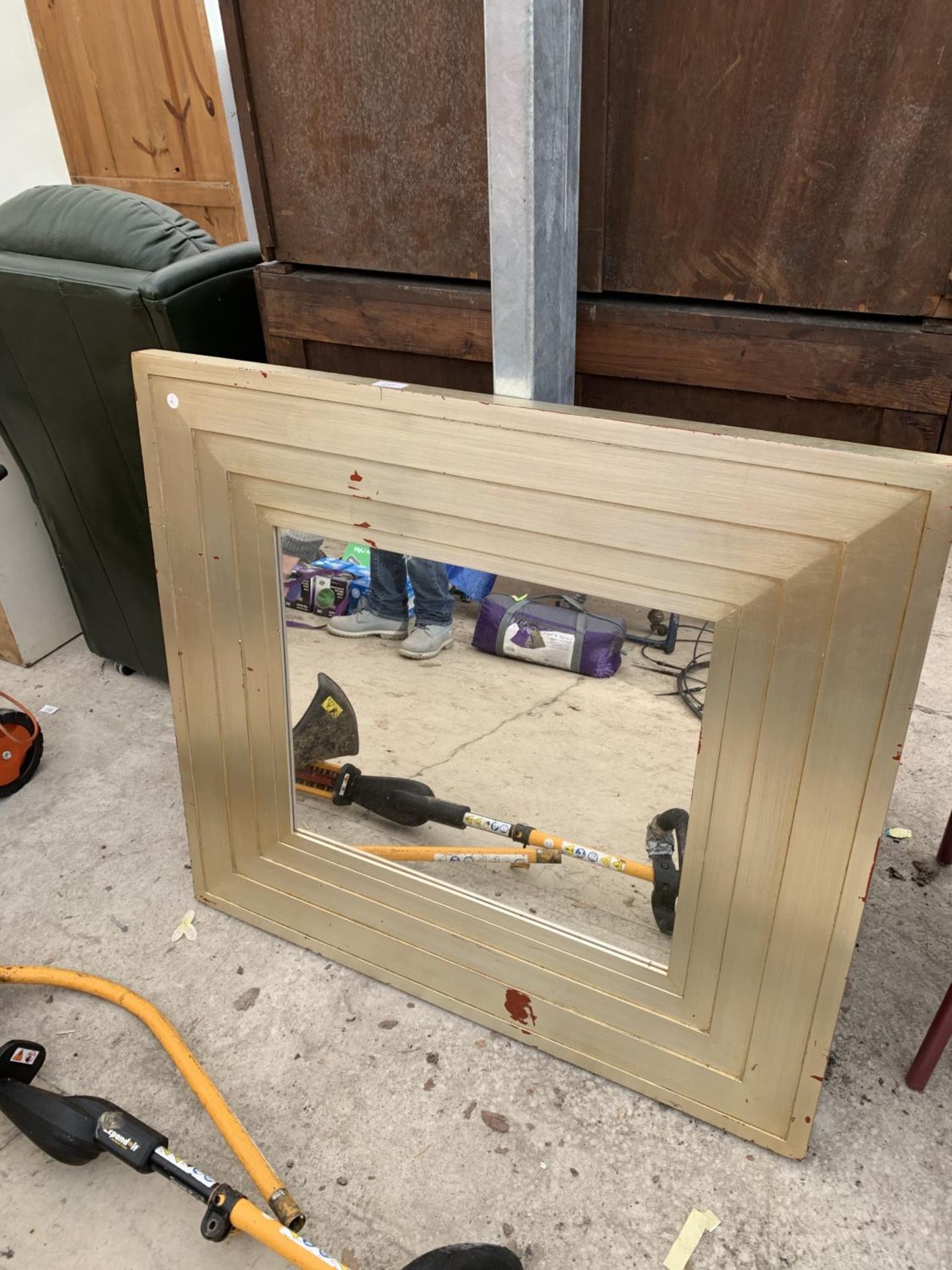 A LARGE GILT FRAMED MIRROR