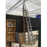 TWO EXTENDING LADDERS - ONE ALUMINIUM TWENTY FOUR RUNG TWO SECTION AND ONE WOODEN THIRTY RUNG TWO