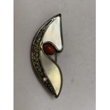 A SILVER AND RED STONE BROOCH