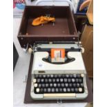 A VINTAGE CASED IMPERIAL GOOD COMPANION TYPEWRITER