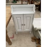A SMALL WHITE PAINTED CABINET WITH TWO DOORS