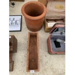 A TERRACOTTA POT AND TERRACOTTA TROUGH