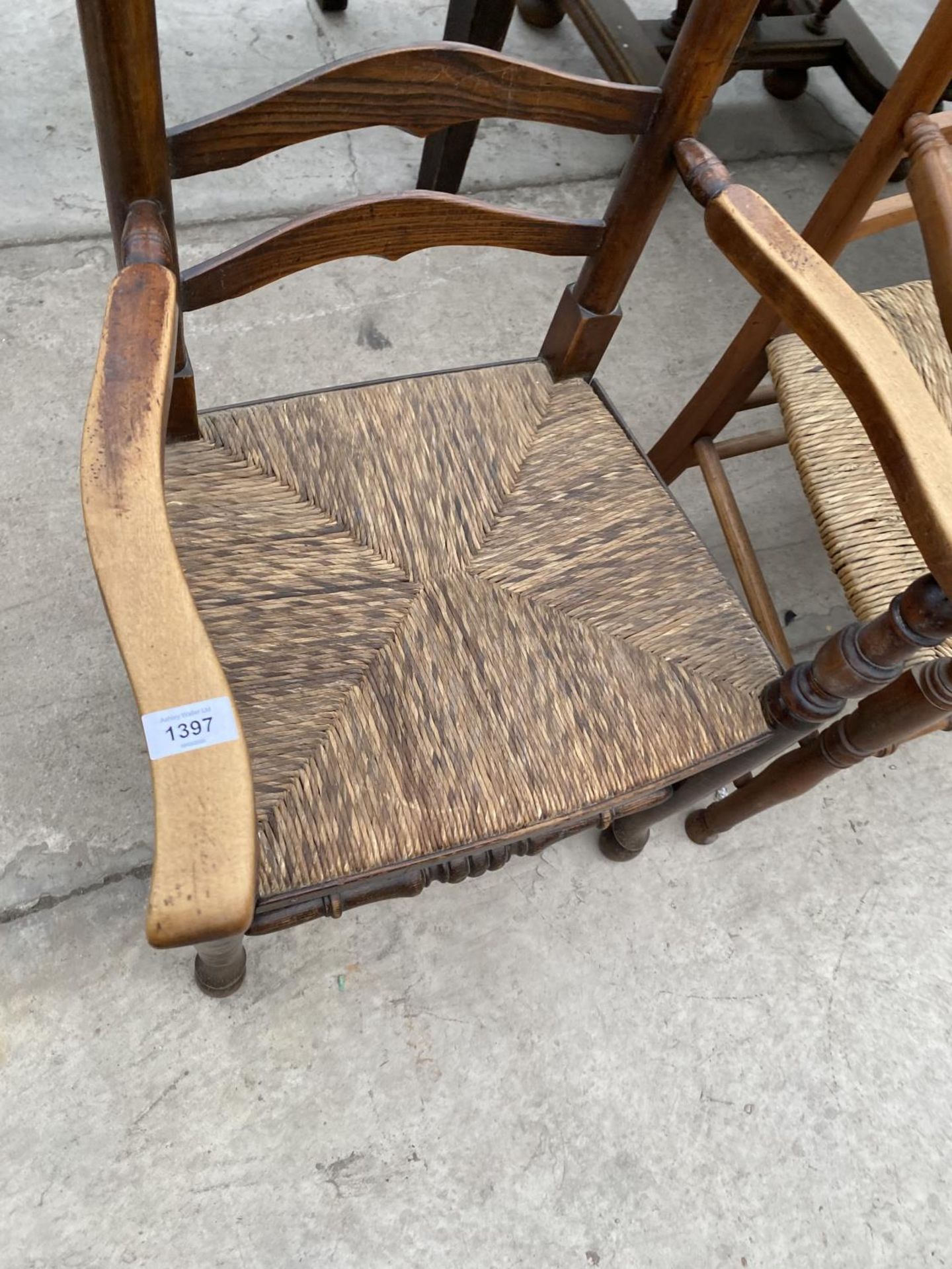 TWO LADDER BACK CARVER DINING CHAIRS WITH RUSH SEATS - ONE OAK, ONE MAHOGANY - Image 2 of 5