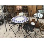 A TILED TOP METAL BISTRO TABLE WITH THREE METAL FOLDING CHAIRS