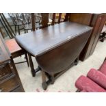 AN OAK DROP LEAF DINING TABLE